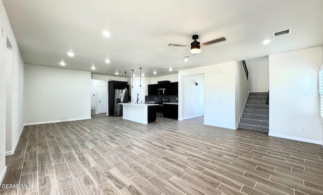 14617 Tierra Nectar Ave, El Paso, TX 79938 - kitchen with a kitchen island with sink, light countertops, open floor plan, stainless steel refrigerator with ice dispenser, and visible vents