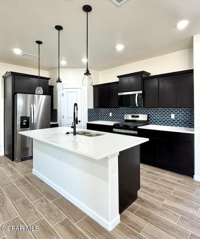 14617 Tierra Nectar Ave, El Paso, TX 79938 - kitchen featuring dark cabinets, a sink, appliances with stainless steel finishes, and wood tiled floor