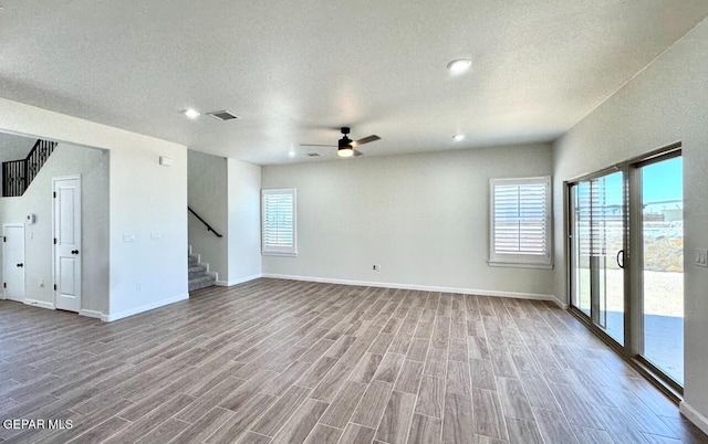 14617 Tierra Nectar Ave, El Paso, TX 79938 - unfurnished living room featuring baseboards, a ceiling fan, wood finished floors, and stairway