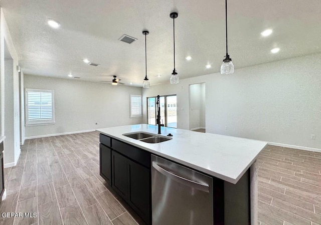 14617 Tierra Nectar Ave, El Paso, TX 79938 - kitchen with wood tiled floor, visible vents, stainless steel dishwasher, light countertops, and open floor plan