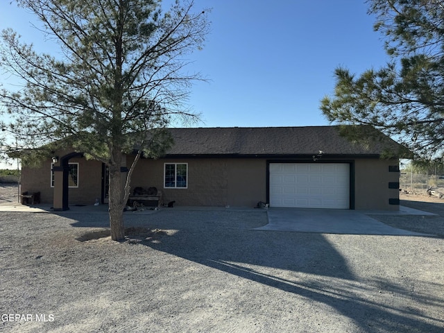 121 Compa Dr, Tornillo, TX 79853 - view of front of home with driveway, an attached garage, roof with shingles, and stucco siding