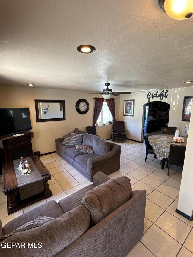 121 Compa Dr, Tornillo, TX 79853 - living area with light tile patterned floors, a ceiling fan, and a textured ceiling