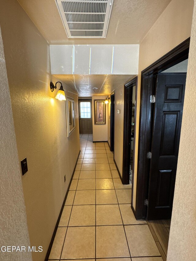 121 Compa Dr, Tornillo, TX 79853 - corridor with a textured wall and light tile patterned flooring