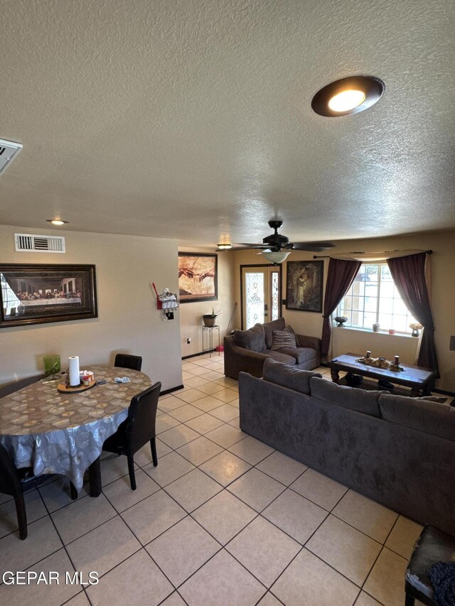 121 Compa Dr, Tornillo, TX 79853 - living area with a textured ceiling, light tile patterned floors, and a ceiling fan