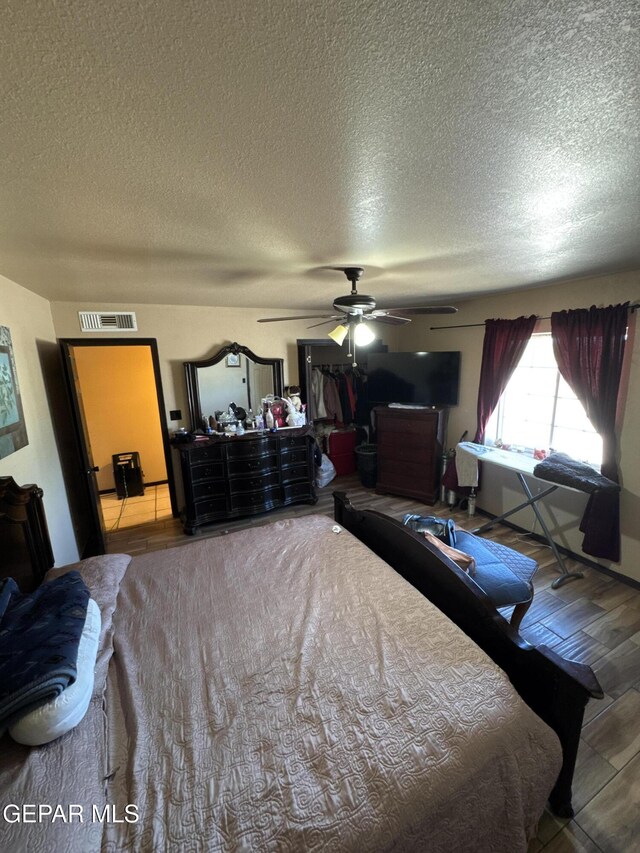 121 Compa Dr, Tornillo, TX 79853 - bedroom with a textured ceiling, wood finished floors, and a ceiling fan