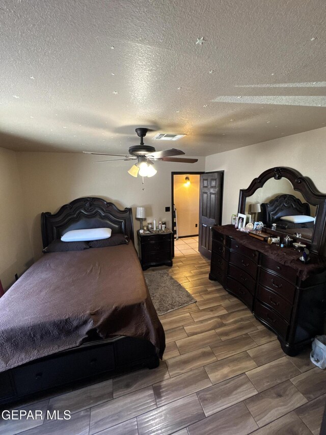 121 Compa Dr, Tornillo, TX 79853 - bedroom with a textured ceiling, wood finish floors, and ceiling fan