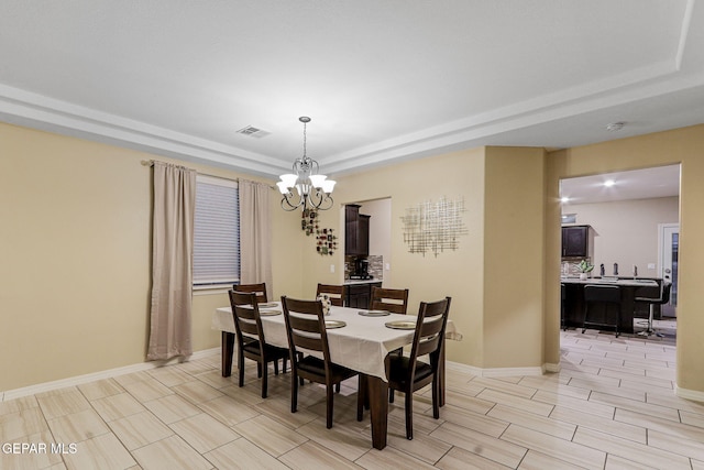 14717 Tierra Escape Ave, El Paso, TX 79938 - dining space featuring a raised ceiling, a chandelier, and baseboards
