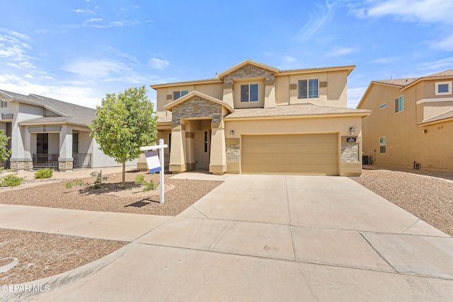 14717 Tierra Escape Ave, El Paso, TX 79938 - view of front of house with stucco siding, stone siding, driveway, and an attached garage