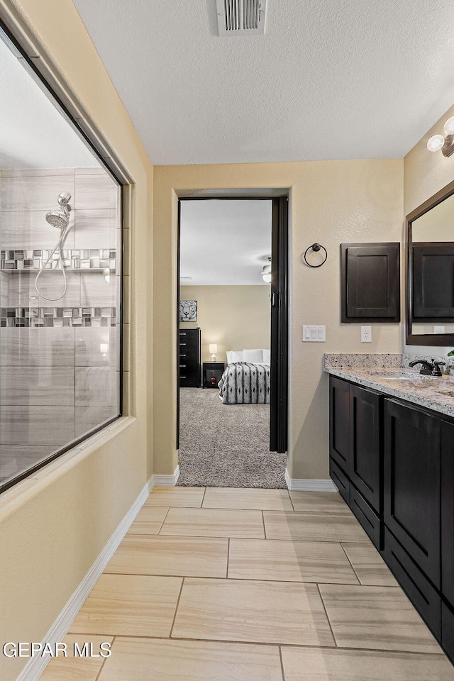 14717 Tierra Escape Ave, El Paso, TX 79938 - full bathroom featuring vanity, a textured ceiling, and baseboards