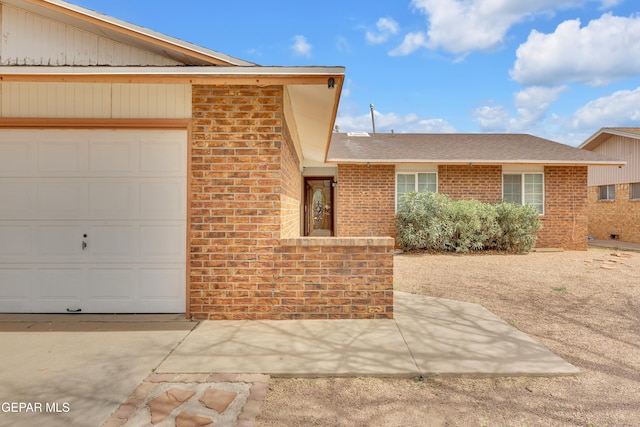 view of front of property featuring brick siding and an attached garage