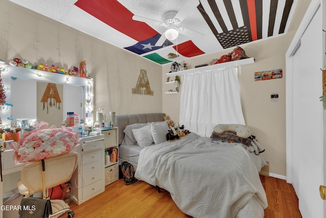 bedroom featuring wood finished floors and a ceiling fan
