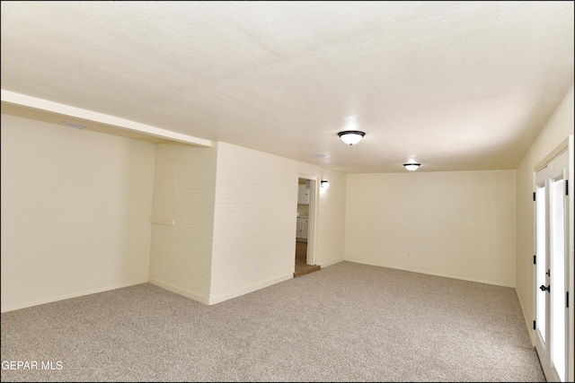 carpeted empty room with a textured ceiling