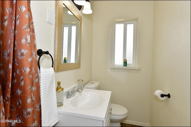 bathroom featuring toilet and vanity