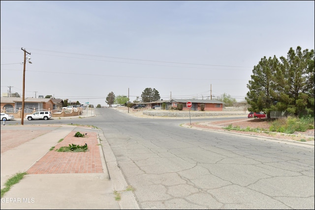 view of street featuring sidewalks, traffic signs, and curbs