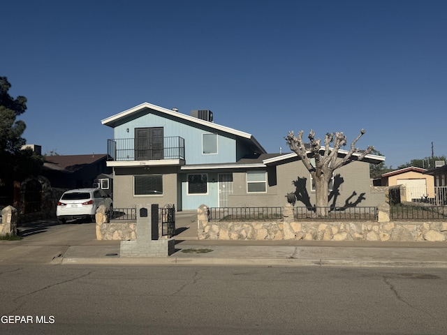 3316 Slocum St, El Paso, TX 79936 - traditional-style house with central AC, a fenced front yard, and a balcony
