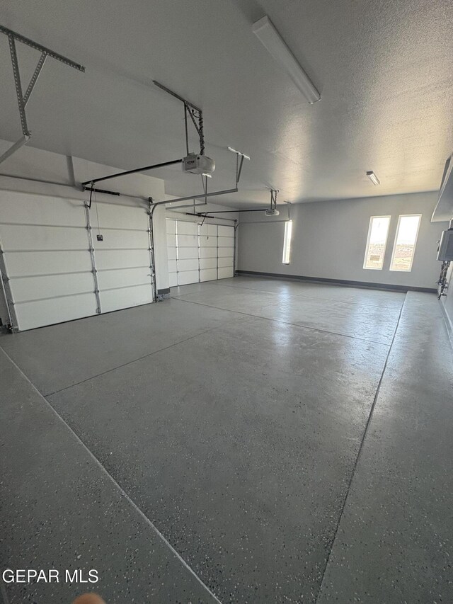 7367 Cimarron Rim Dr, El Paso, TX 79911 - garage featuring a garage door opener and baseboards