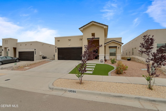 view of front of house with concrete driveway, stone siding, a garage, and stucco siding
