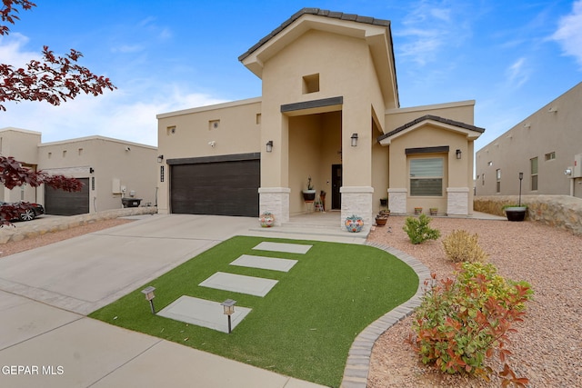 view of front of house featuring a garage, driveway, stucco siding, and stone siding