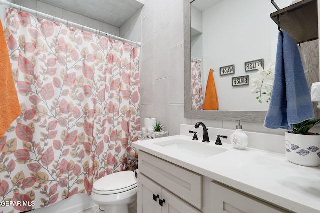 full bathroom with toilet, shower / tub combo with curtain, and vanity