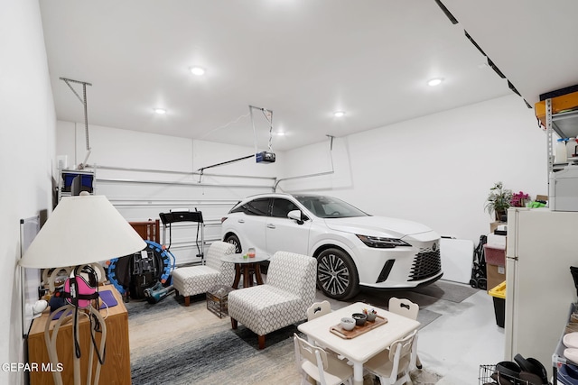garage with recessed lighting and a garage door opener