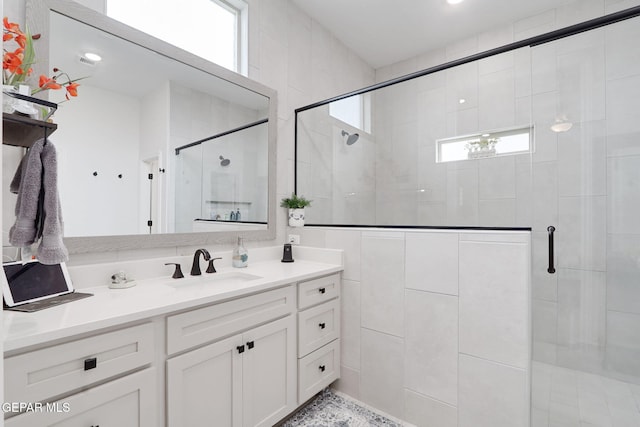 bathroom featuring a shower stall and vanity