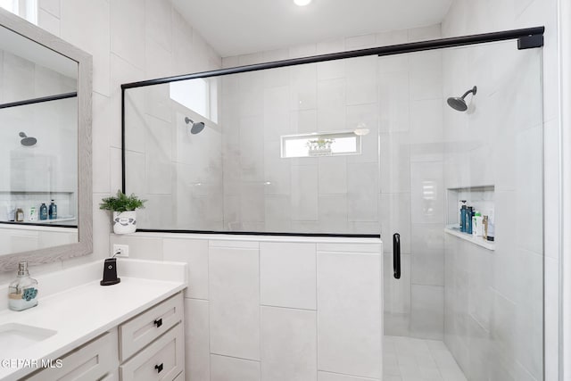 bathroom with a stall shower and vanity