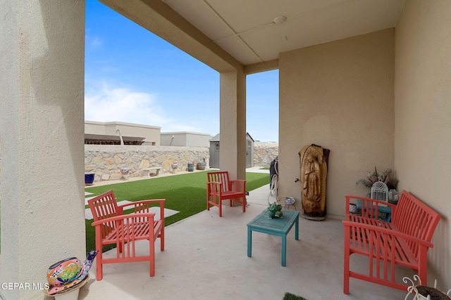 view of patio with an outdoor structure and a storage unit