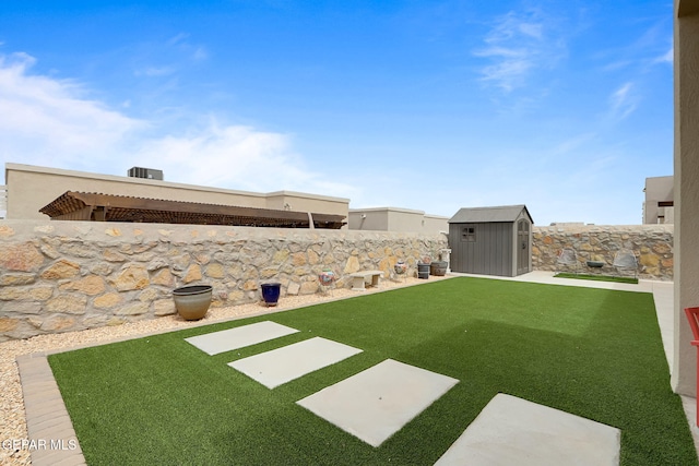 view of yard featuring a storage shed, a fenced backyard, and an outdoor structure