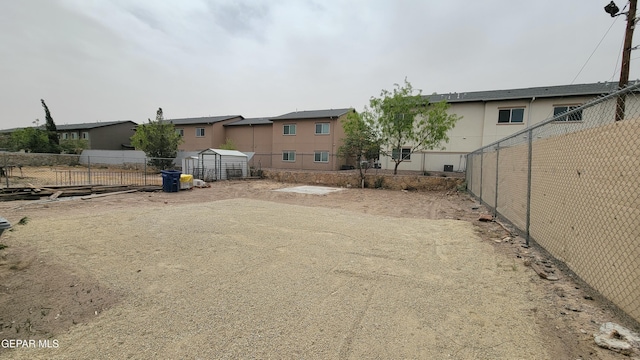 231 Francis St, El Paso, TX 79905 - view of yard featuring fence, an outdoor structure, and a residential view