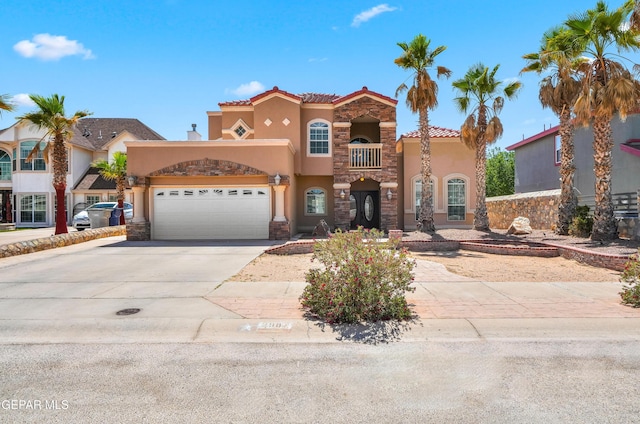 2987 Tierra Limon Dr, El Paso, TX 79938 - view of front of home with driveway, stucco siding, stone siding, a garage, and a tiled roof