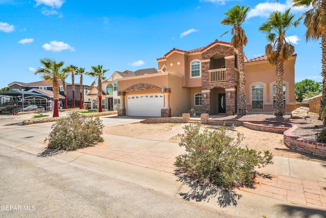 2987 Tierra Limon Dr, El Paso, TX 79938 - mediterranean / spanish-style home with stucco siding, stone siding, concrete driveway, and a garage