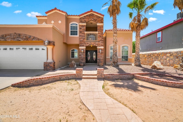 2987 Tierra Limon Dr, El Paso, TX 79938 - mediterranean / spanish-style home with stucco siding, french doors, a tile roof, concrete driveway, and a garage