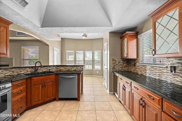 2987 Tierra Limon Dr, El Paso, TX 79938 - kitchen featuring stainless steel appliances, a sink, decorative backsplash, and light tile patterned flooring