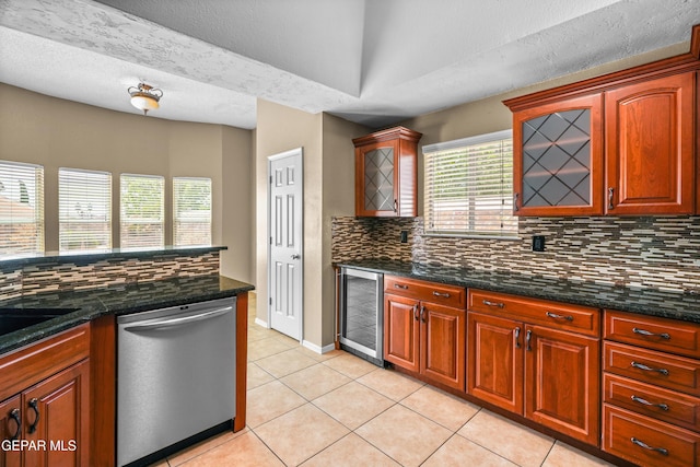 2987 Tierra Limon Dr, El Paso, TX 79938 - kitchen featuring stainless steel dishwasher, wine cooler, decorative backsplash, light tile patterned floors, and dark stone counters