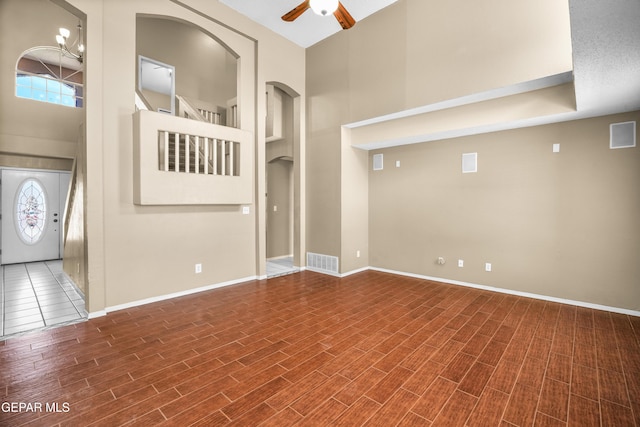 2987 Tierra Limon Dr, El Paso, TX 79938 - empty room featuring a towering ceiling, ceiling fan, wood finished floors, and baseboards
