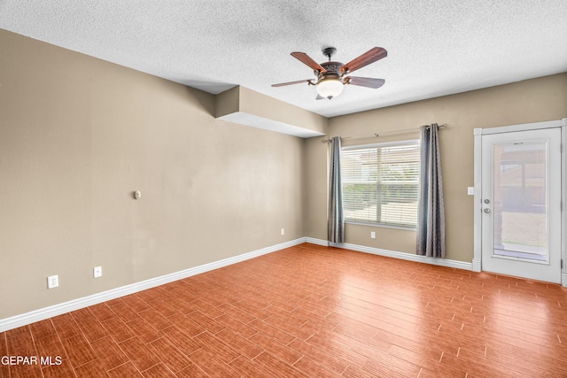 2987 Tierra Limon Dr, El Paso, TX 79938 - unfurnished room featuring a ceiling fan, baseboards, a textured ceiling, and wood finished floors