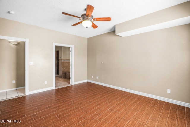 2987 Tierra Limon Dr, El Paso, TX 79938 - unfurnished bedroom with wood finished floors, baseboards, and connected bathroom