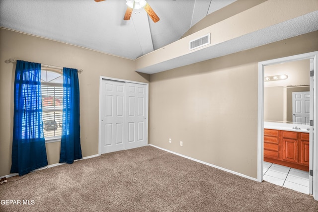 2987 Tierra Limon Dr, El Paso, TX 79938 - unfurnished bedroom with light colored carpet, lofted ceiling, a closet, baseboards, and ensuite bathroom