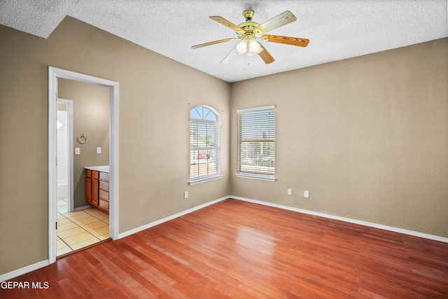 2987 Tierra Limon Dr, El Paso, TX 79938 - unfurnished room featuring light wood-style floors, ceiling fan, a textured ceiling, and baseboards