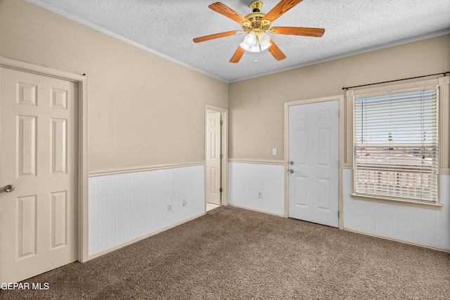 2987 Tierra Limon Dr, El Paso, TX 79938 - unfurnished bedroom with a textured ceiling, a wainscoted wall, carpet floors, ornamental molding, and a closet