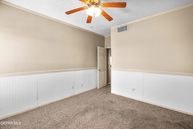 2987 Tierra Limon Dr, El Paso, TX 79938 - carpeted spare room featuring a wainscoted wall, a textured ceiling, ceiling fan, and ornamental molding