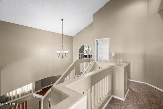 2987 Tierra Limon Dr, El Paso, TX 79938 - stairs featuring high vaulted ceiling, carpet, baseboards, and a chandelier