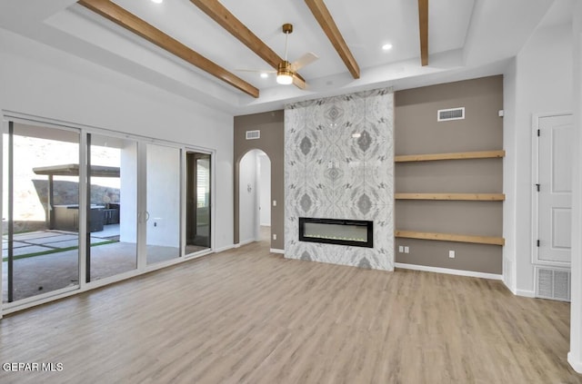 1846 Pommel Pl, El Paso, TX 79911 - unfurnished living room with wood finished floors, visible vents, arched walkways, beam ceiling, and ceiling fan