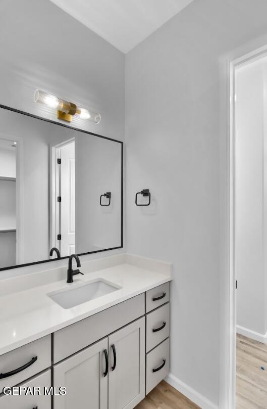 1846 Pommel Pl, El Paso, TX 79911 - bathroom featuring baseboards, wood finished floors, and vanity