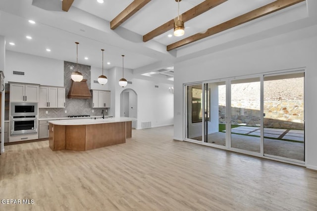 1846 Pommel Pl, El Paso, TX 79911 - kitchen with light wood finished floors, stainless steel appliances, a sink, open floor plan, and light countertops