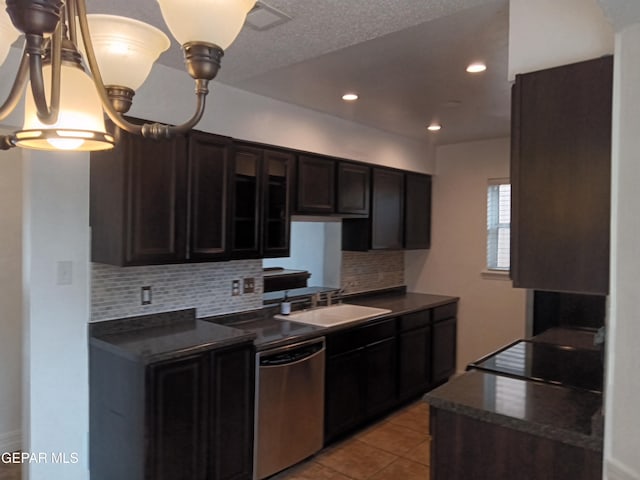 kitchen with a sink, dark countertops, stove, and stainless steel dishwasher