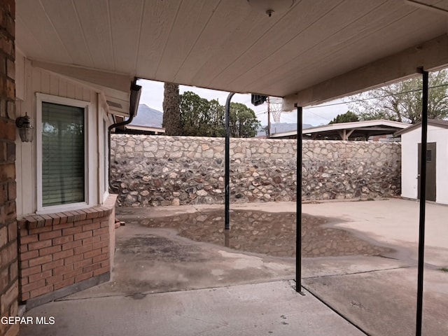 view of patio with a fenced backyard, an outdoor structure, and a storage shed