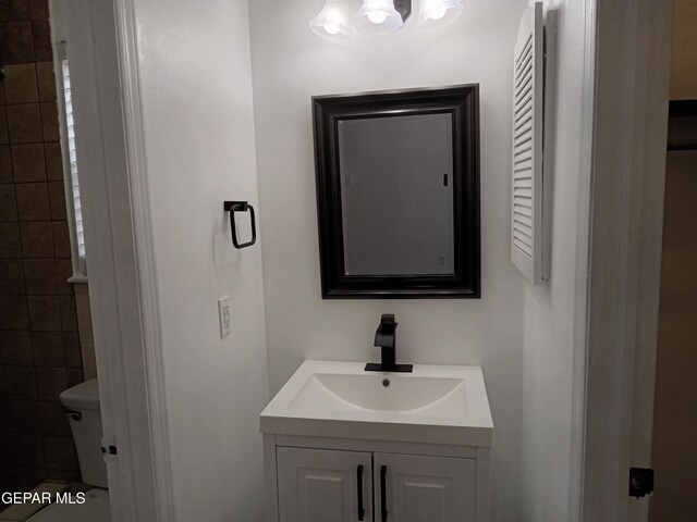 bathroom featuring toilet and vanity