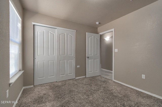 10677 Canyon Sage Dr, El Paso, TX 79924 - unfurnished bedroom with carpet, multiple windows, a closet, and baseboards