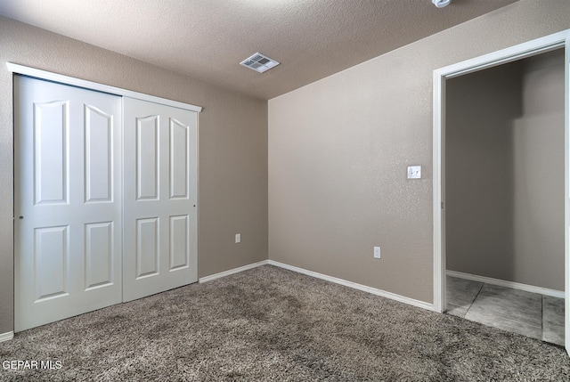 10677 Canyon Sage Dr, El Paso, TX 79924 - unfurnished bedroom with carpet flooring, a closet, a textured ceiling, and baseboards